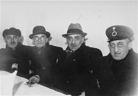 Four members of the Lodz ghetto administration seated at a table